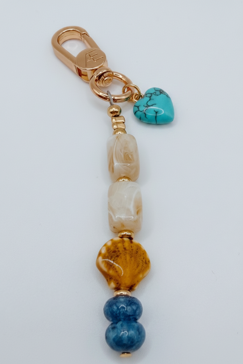 Beaded keychain with 'MAMA' charm on a light gray background